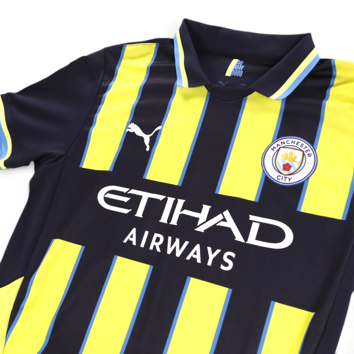 Close-up of Manchester City away shirt collar, crest and Etihad Airways sponsor