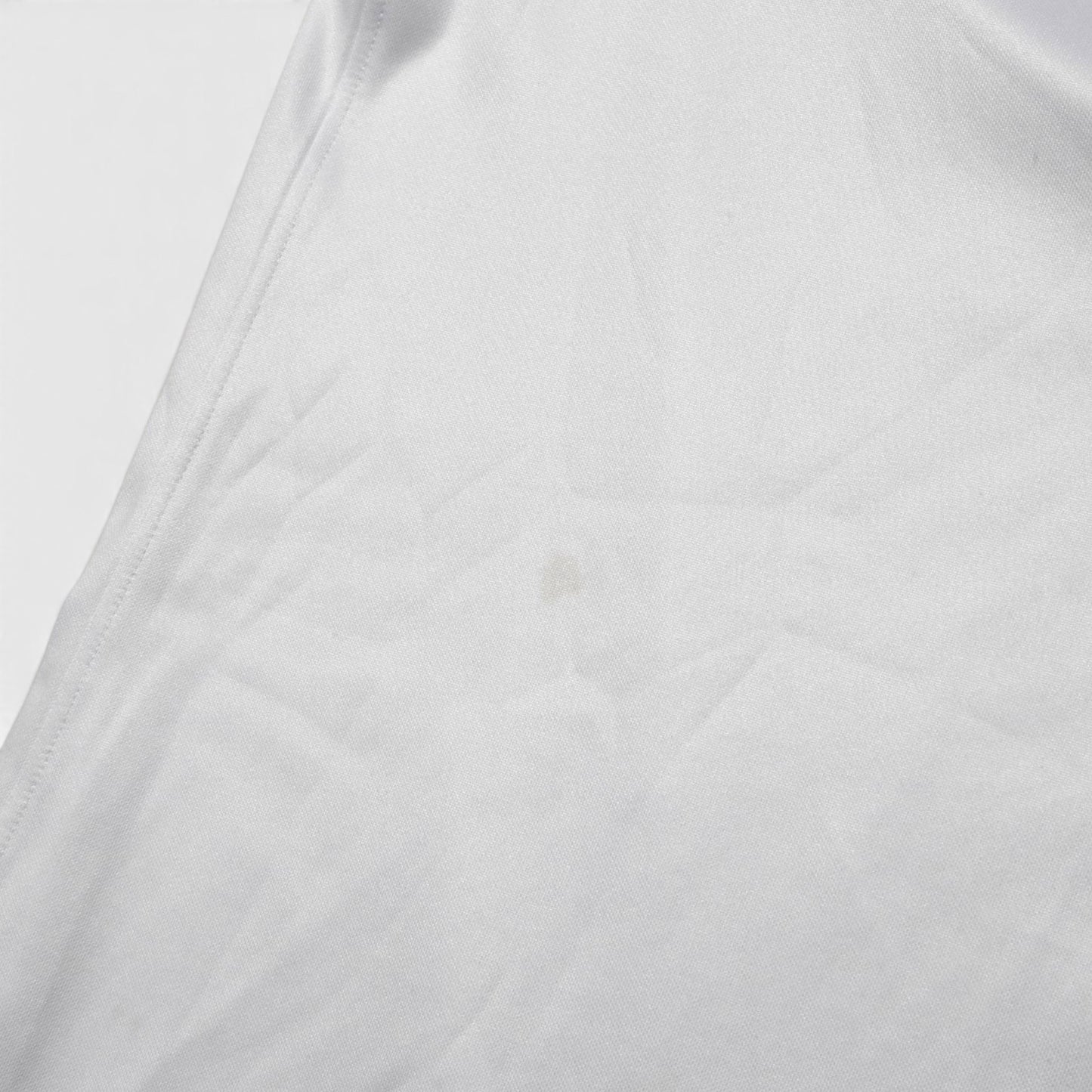 Close-up of fabric on 2022/23 England home shirt showing small mark