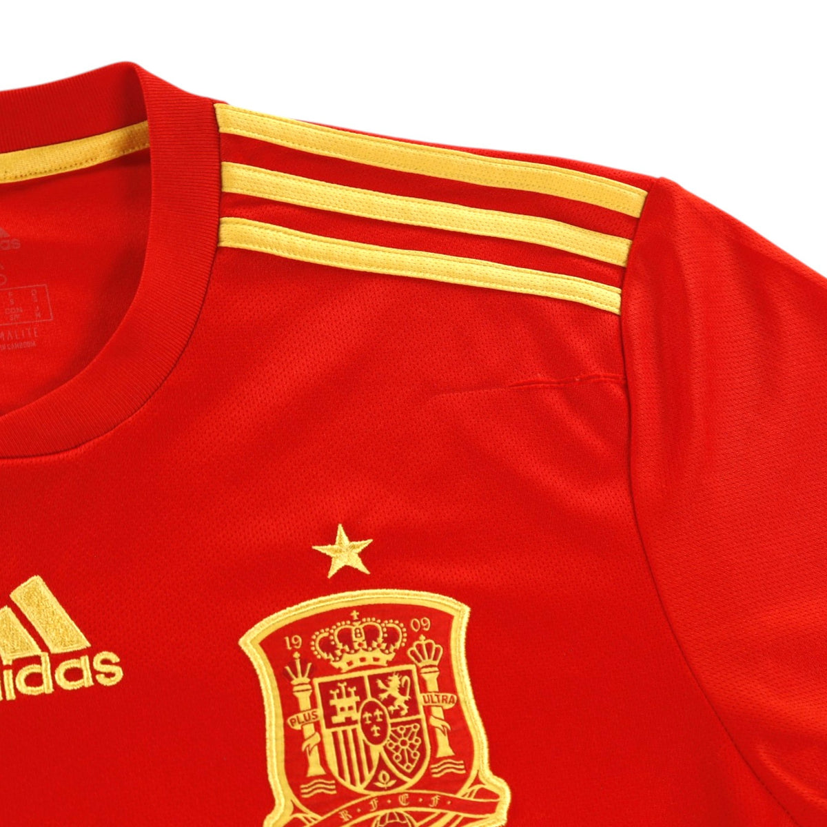 Close-up of the adidas logo, Spanish crest and shoulder stripes on the 2018/19 Spain home shirt