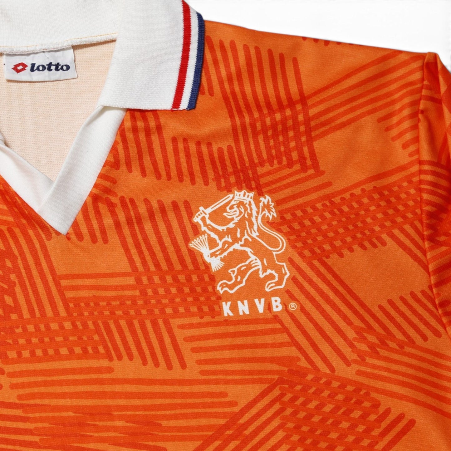 Close-up of KNVB lion crest and Lotto logo on Netherlands home shirt