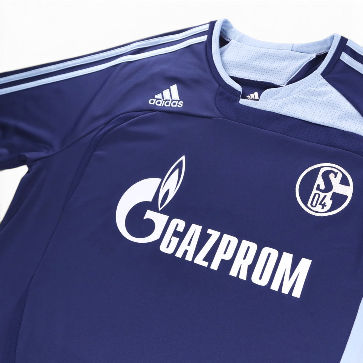 Close-up of adidas logo, Schalke 04 crest and Gazprom sponsor on chest