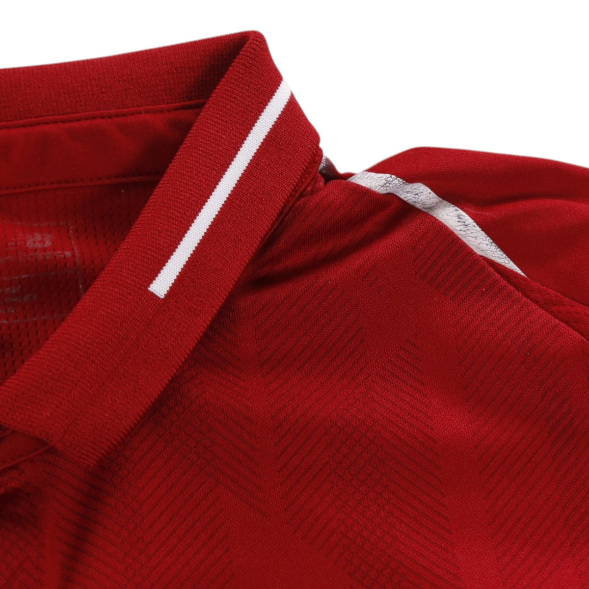 Close-up of collar and shoulder seam with white trim detail