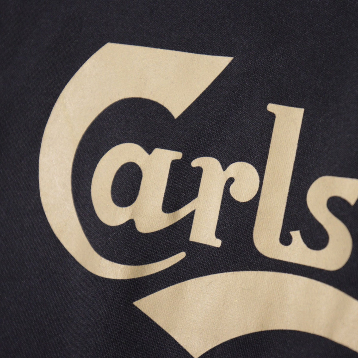 Close-up of Carlsberg sponsor print on shirt front