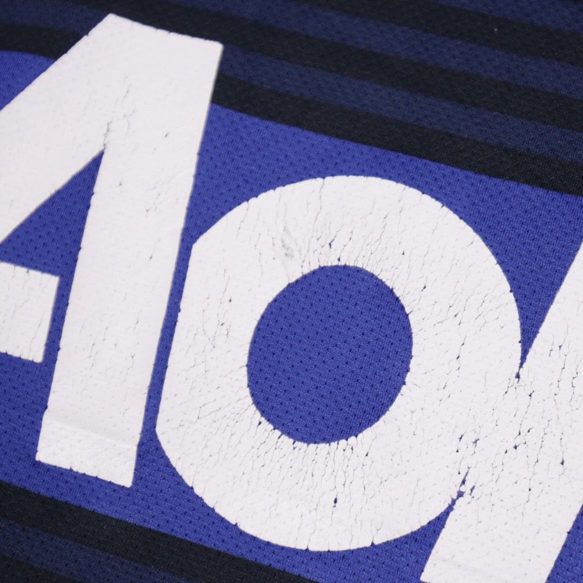 Close-up of cracked Aon sponsor print lettering