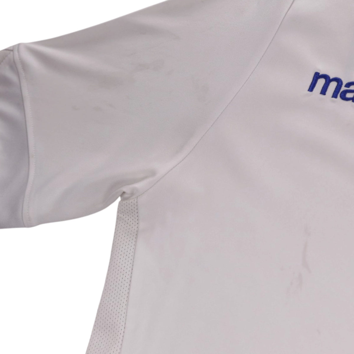 Close-up of shoulder seam and mesh side panel showing faint marks