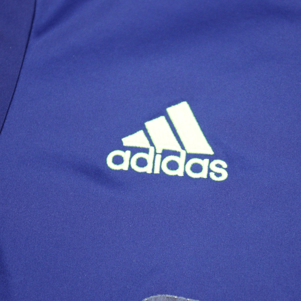 Close-up of adidas logo embroidered on the shirt