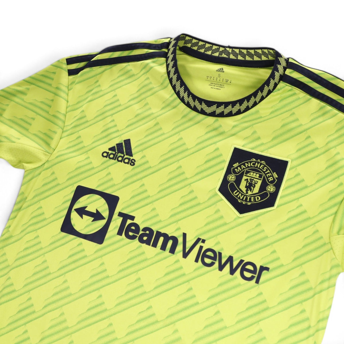 Close-up of adidas logo, Manchester United crest and collar on 2022/23 third shirt