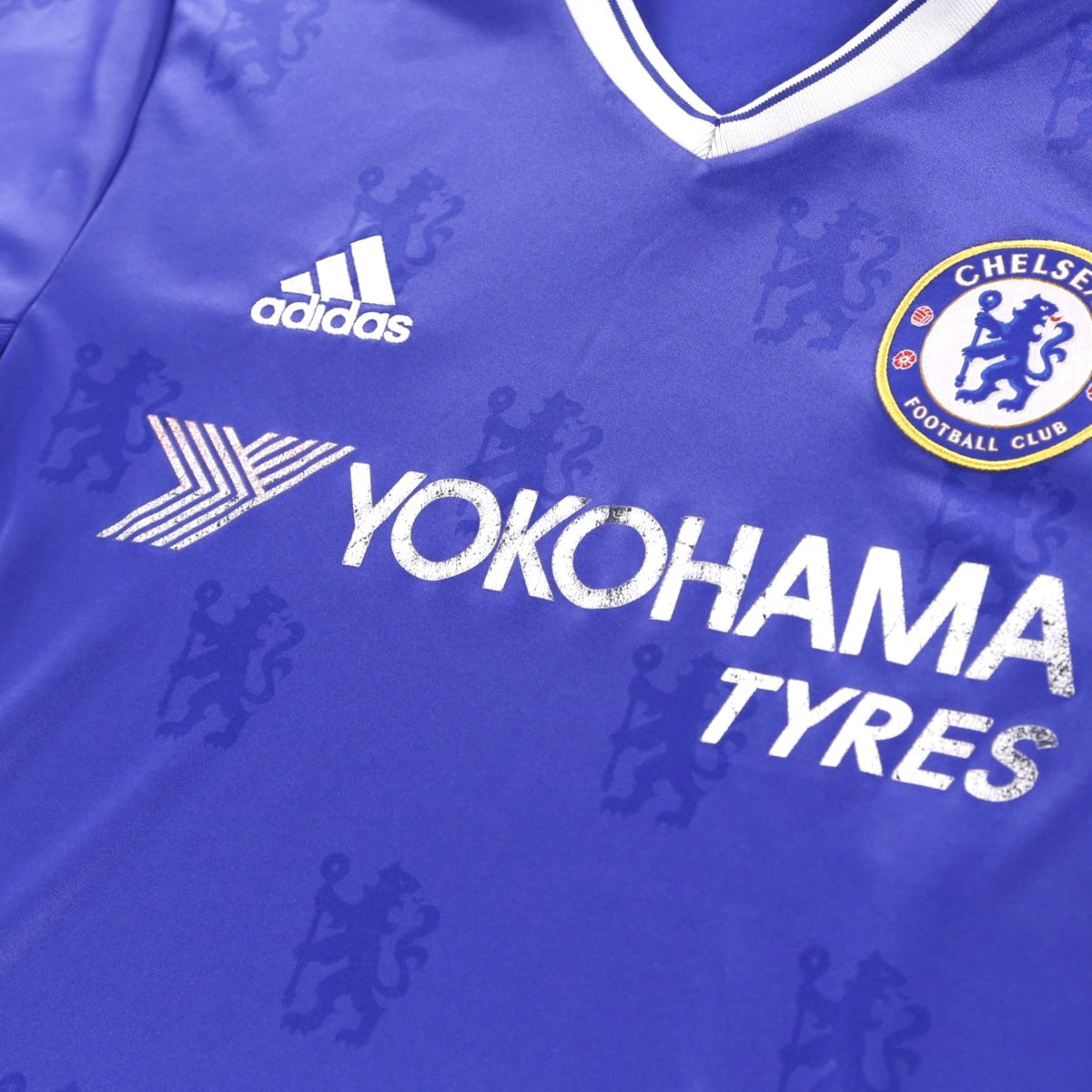 Close-up of the adidas logo, Chelsea crest and Yokohama Tyres sponsor on the chest