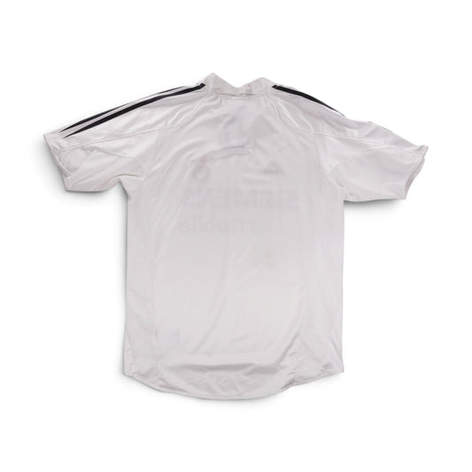 Back of the shirt showing white fabric with black shoulder trim