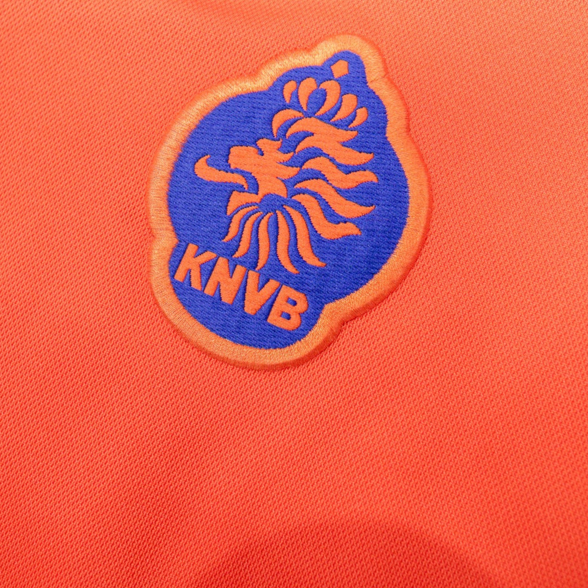 Detailed close-up of the blue and orange KNVB crest on the chest