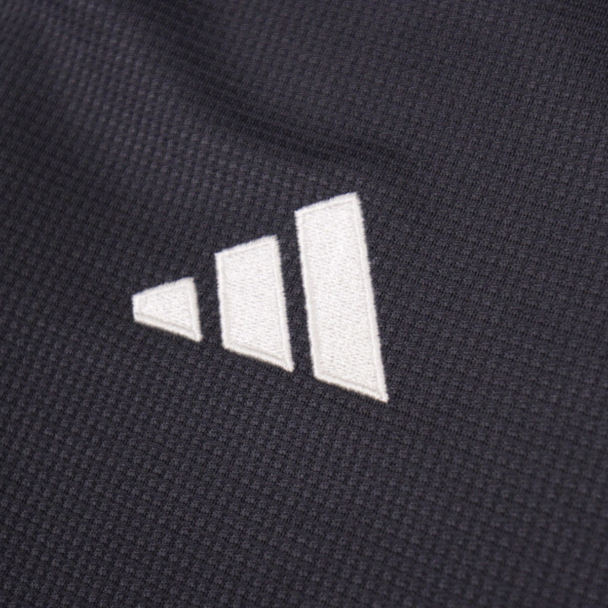 Close-up of the embroidered adidas logo on the Juventus third shirt