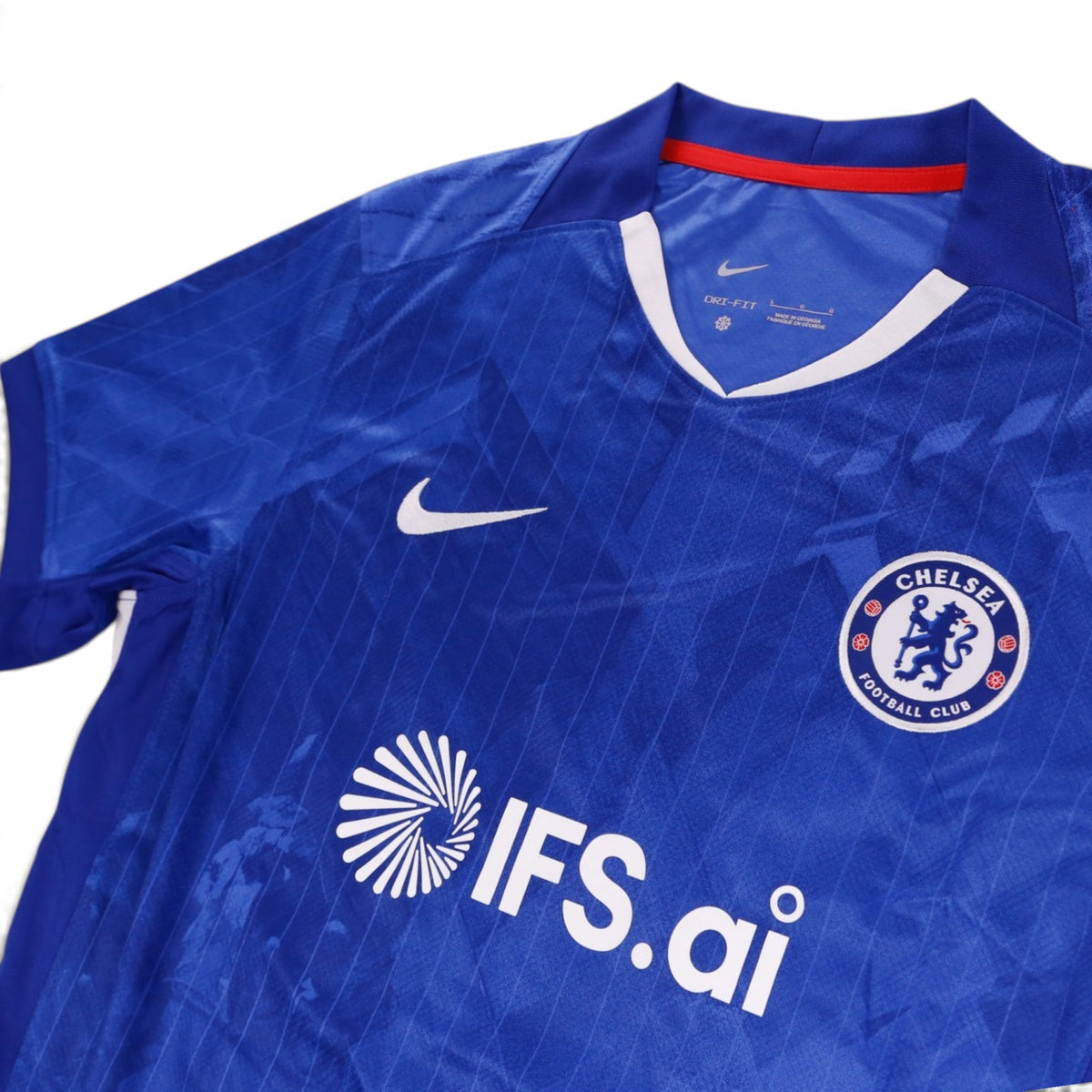 Close-up of the collar, Nike swoosh, crest and sponsor on the front