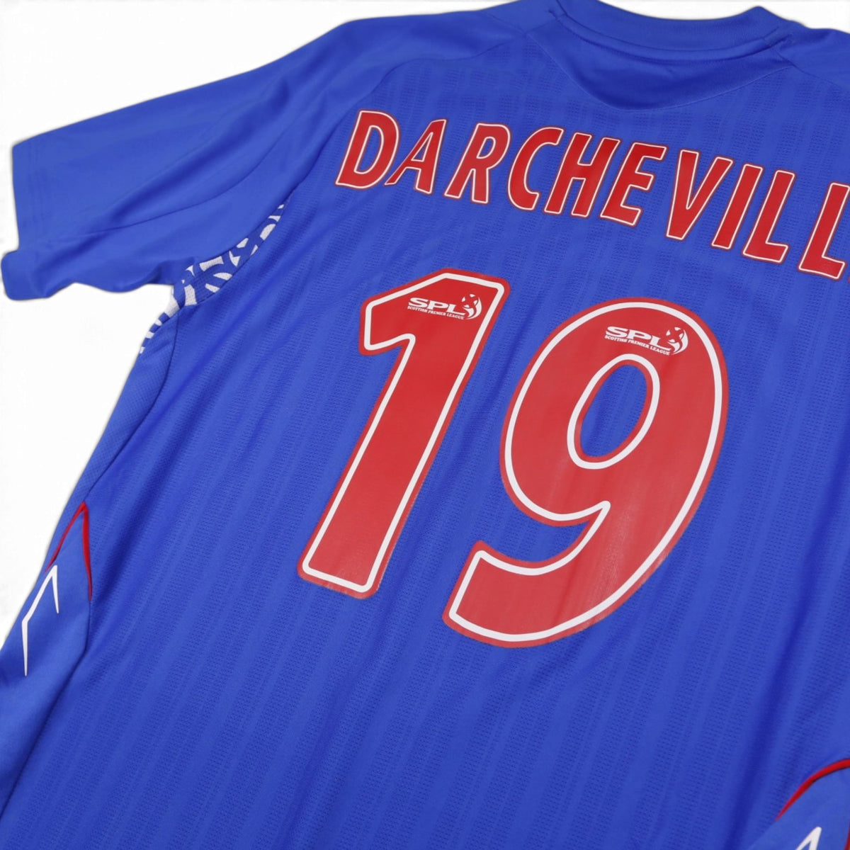 Close-up of Darcheville 19 print and SPL badge on Rangers shirt