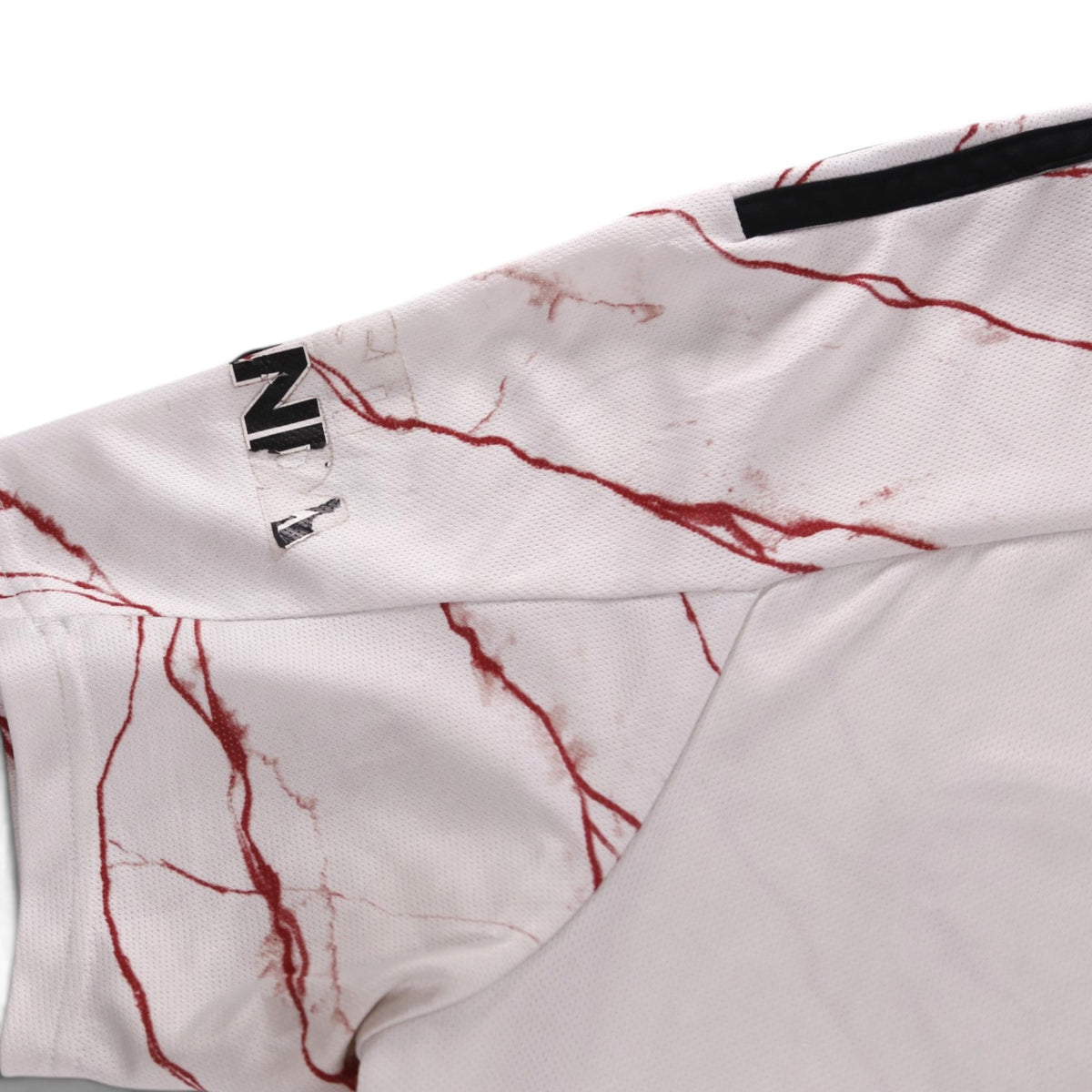 Close-up of sleeve showing Visit Rwanda logo and adidas stripe