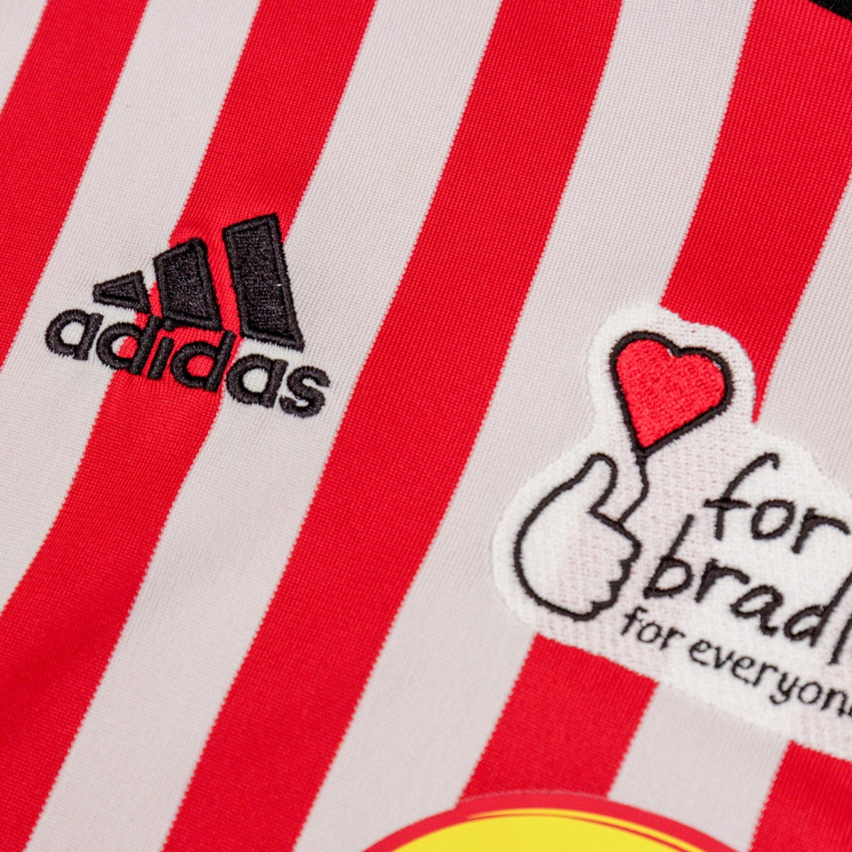 Close-up of the adidas logo and 'for bradley' patch on the home shirt