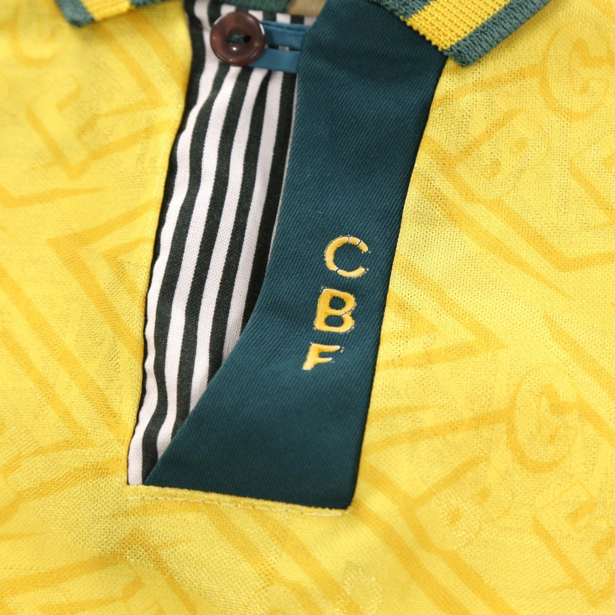 Close-up of striped button placket with CBF lettering on collar