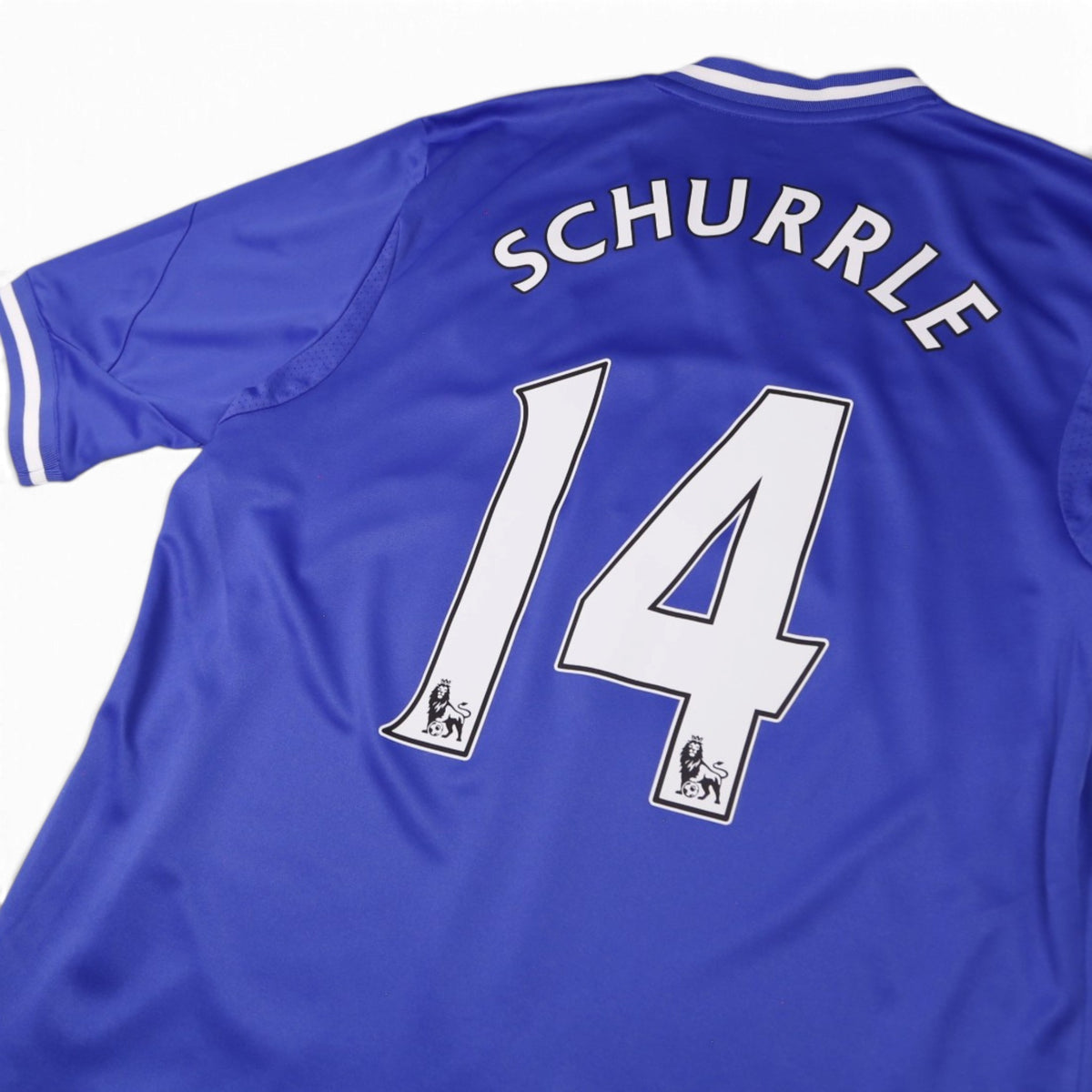 Close-up of Schurrle 14 name and number print with Premier League lion badges