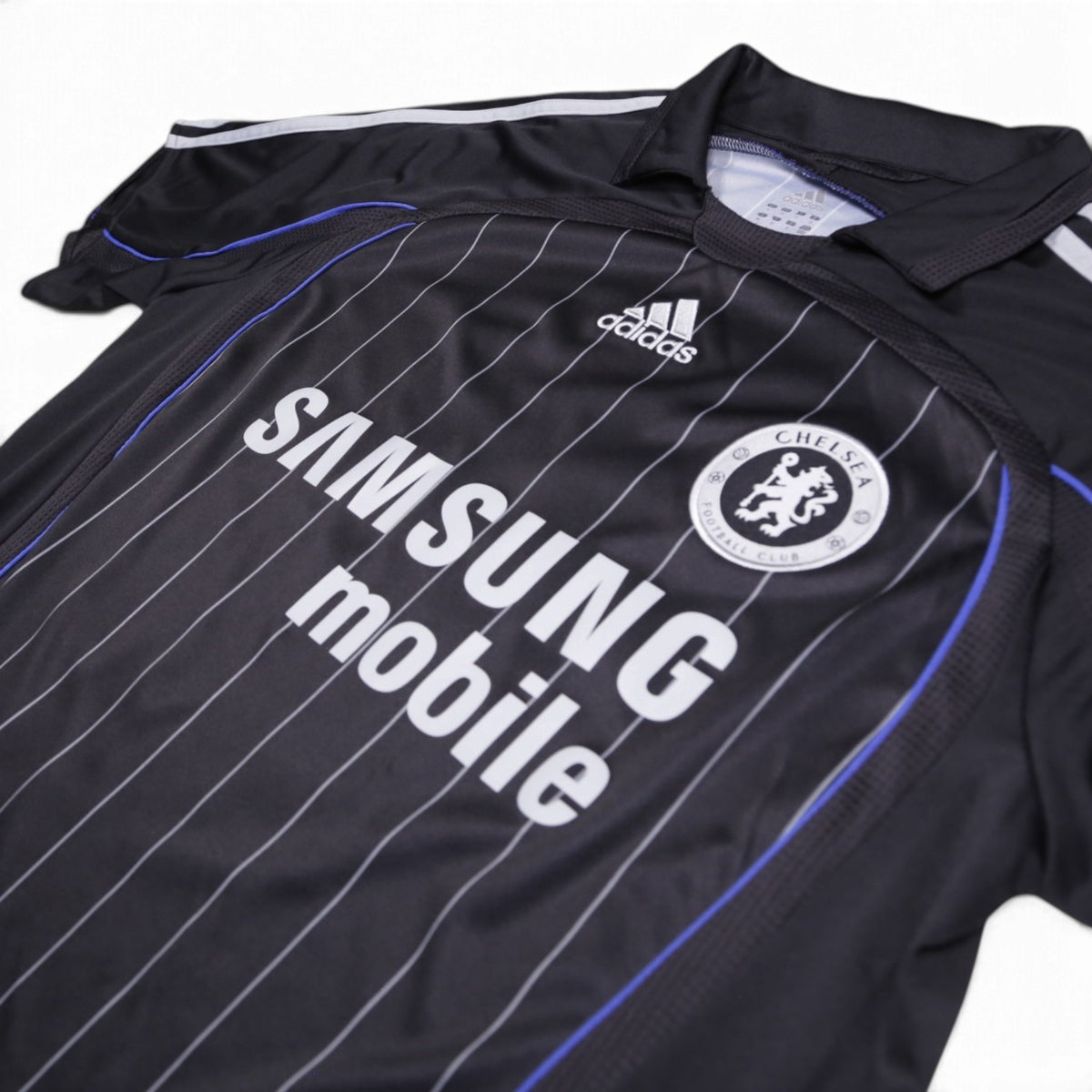 Close-up of adidas logo, Chelsea crest and collar detail on the front