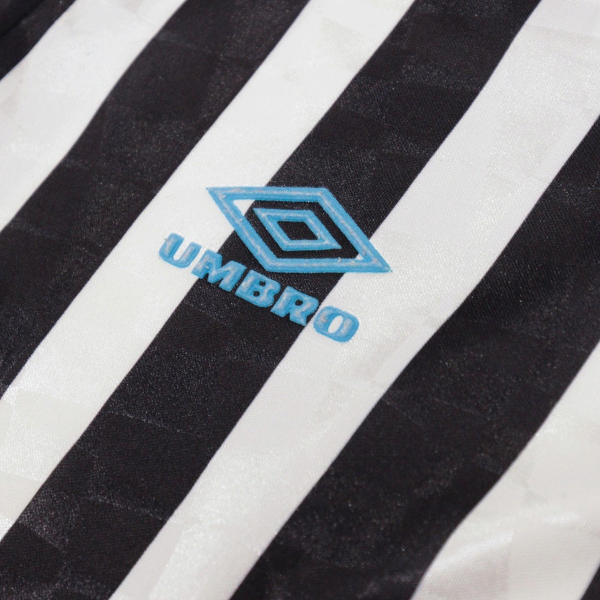 Close-up of Umbro logo printed on sleeve stripe