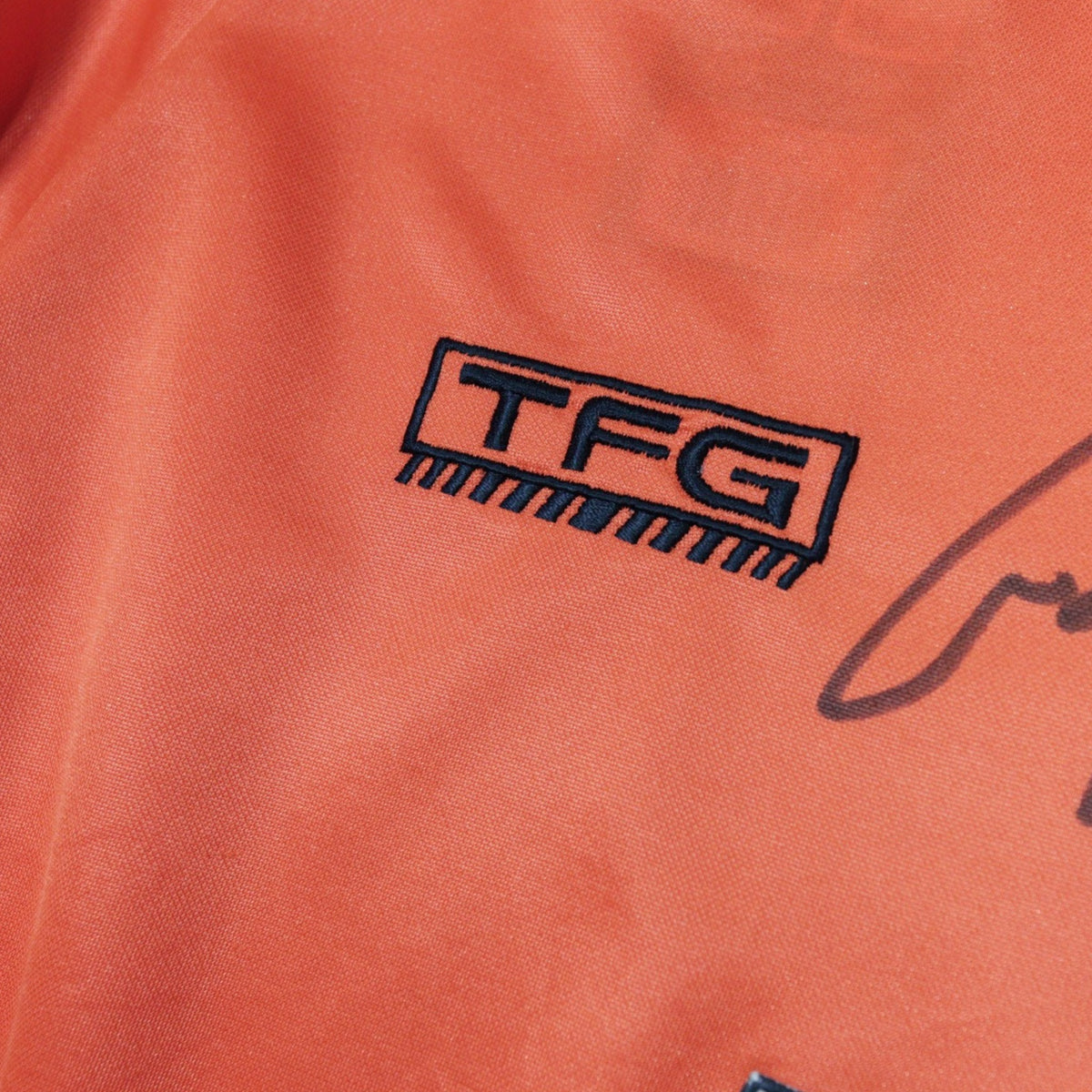 Close-up of the TFG manufacturer logo