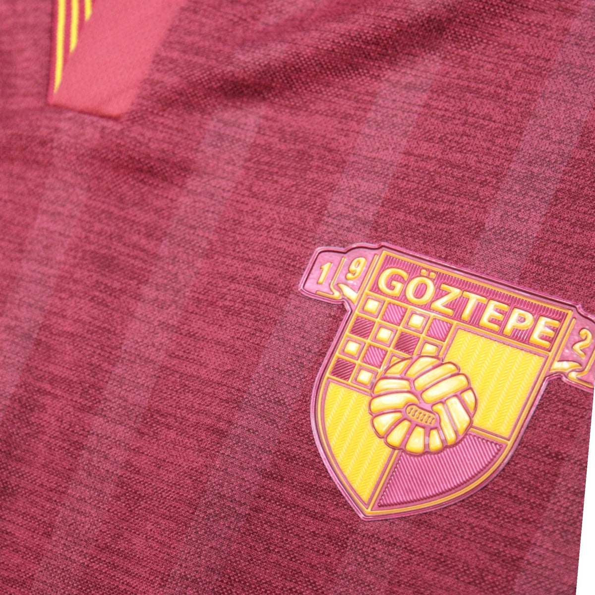 Close-up of the Göztepe SK crest showing the 1925 founding year on the maroon shirt