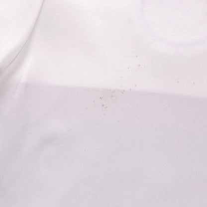 Close-up of small marks on the back of the white shirt fabric