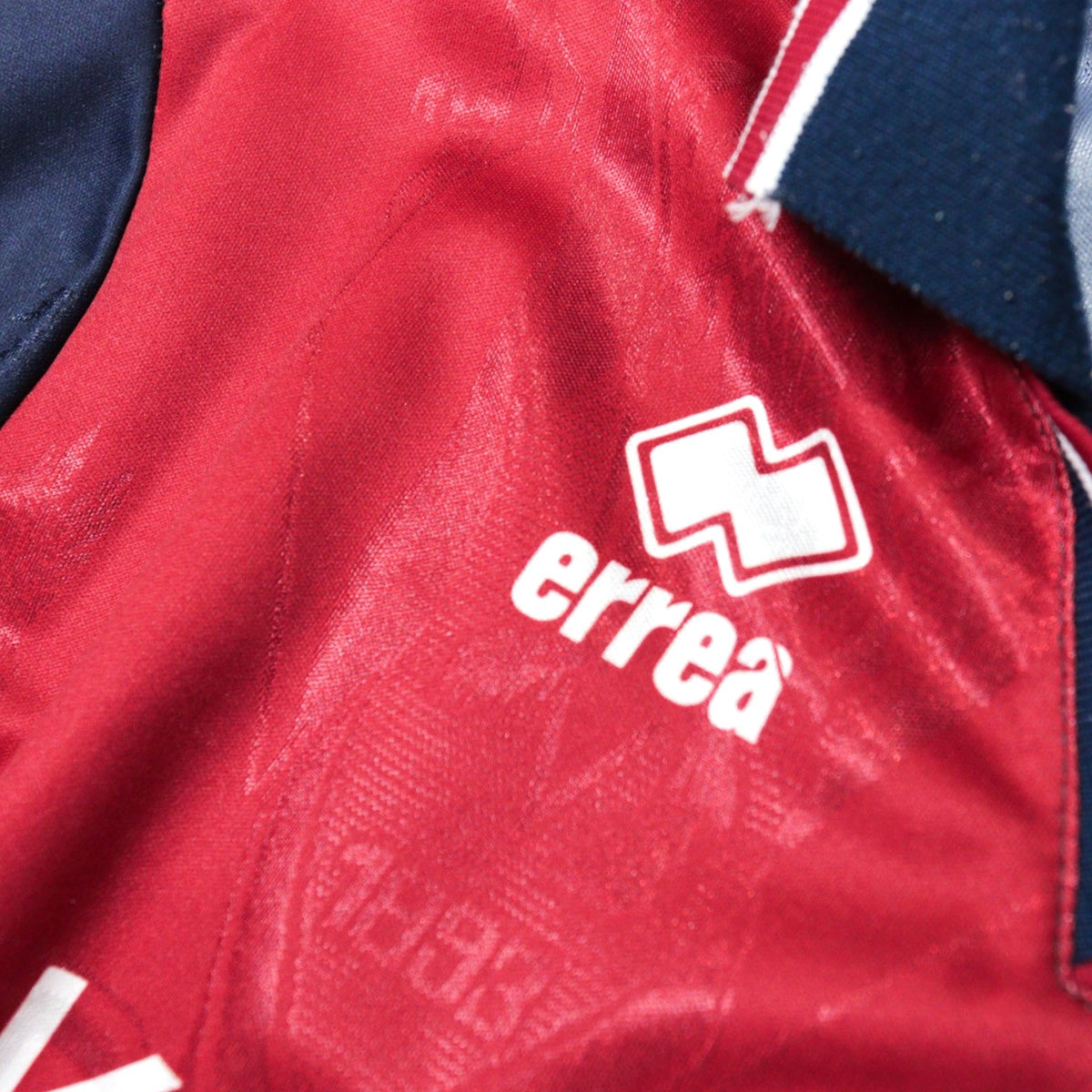 Close-up of the Errea logo printed inside the shirt