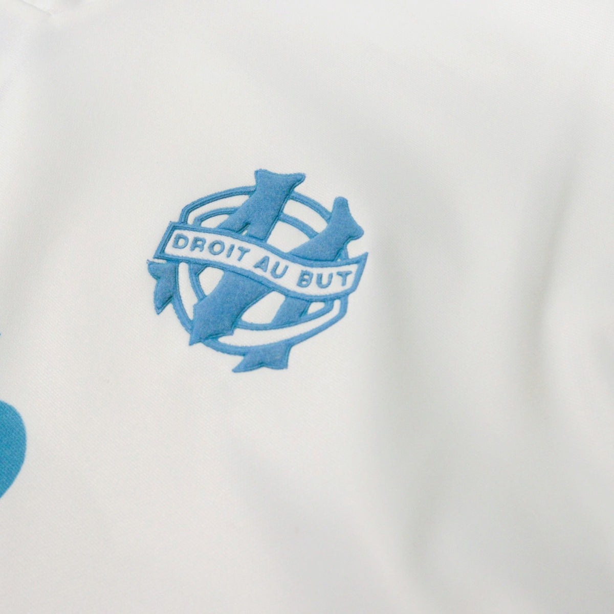 Close-up of the Olympique Marseille crest with "Droit au But" motto