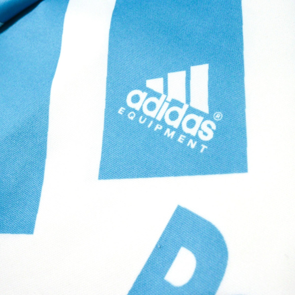 Close-up of the adidas Equipment logo on the shoulder panel