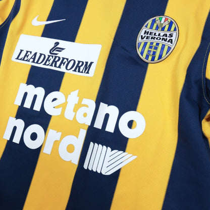 Close-up of the Nike swoosh, Leaderform logo and Hellas Verona crest on the chest