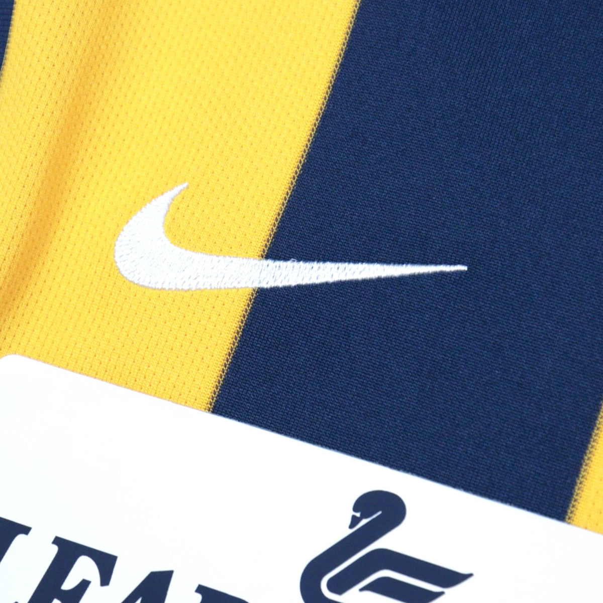 Close-up of the Nike swoosh and Leaderform sponsor logo on the chest