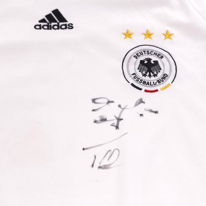 Close-up of adidas logo, Deutscher Fussball-Bund crest with three stars, and signature on the chest