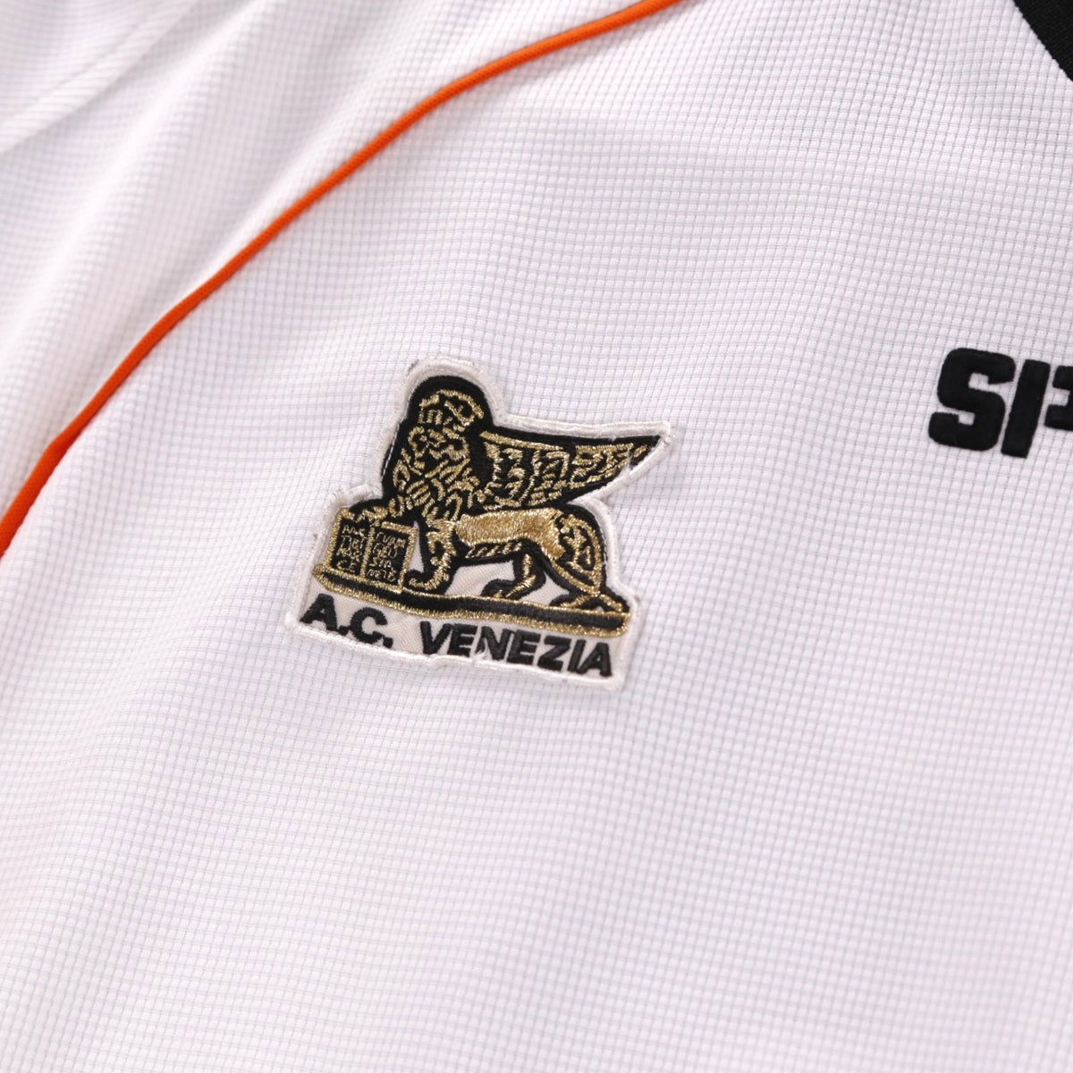 Close-up of the embroidered A.C. Venezia crest with winged lion