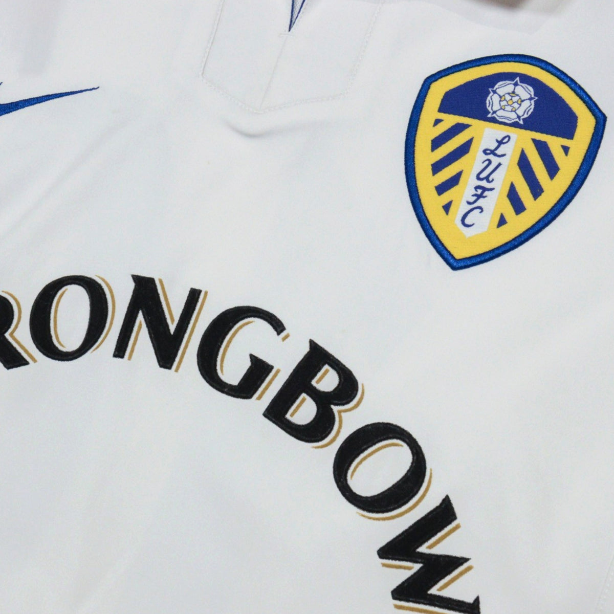 Close-up of the Leeds United crest and Strongbow lettering