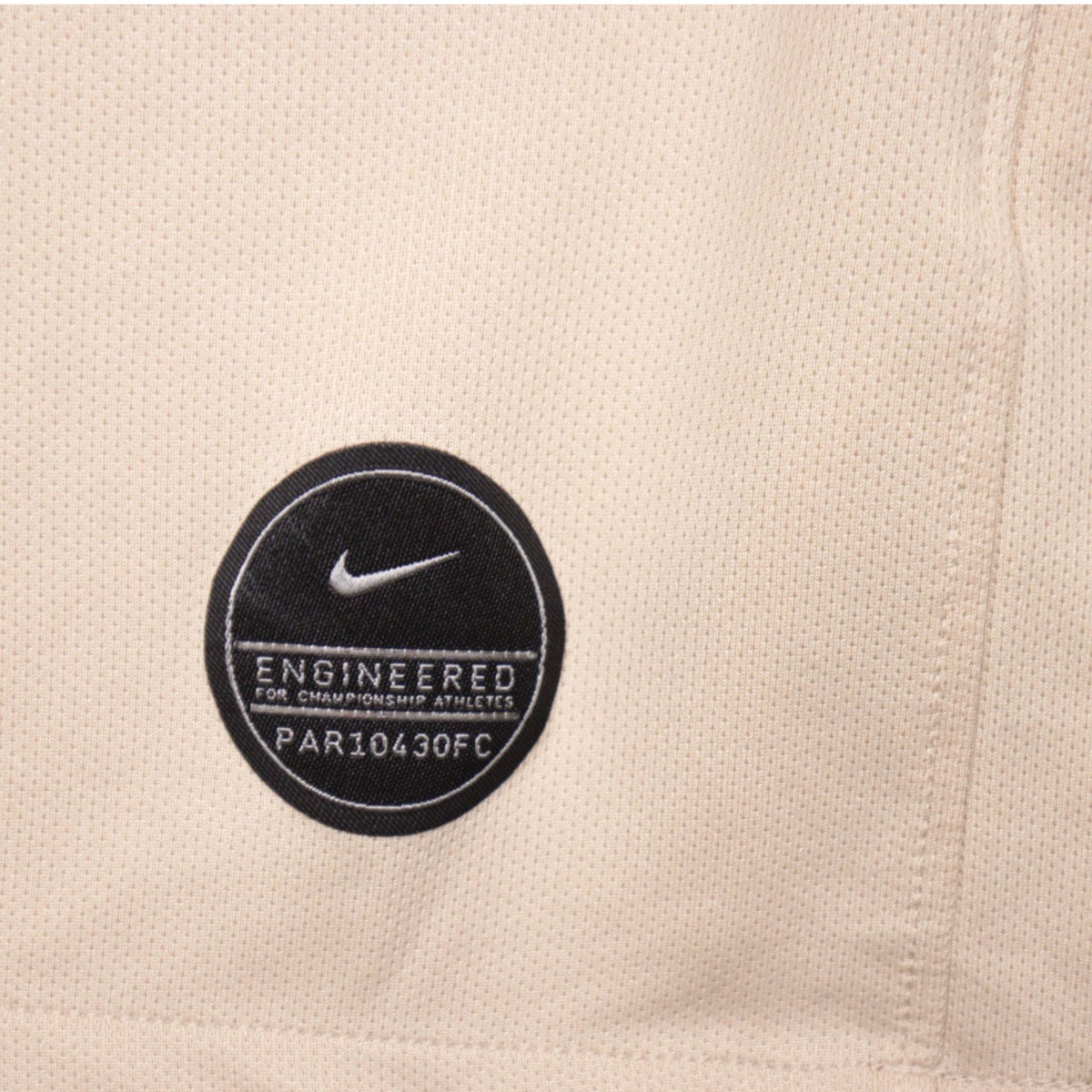 Close-up of the Nike manufacturer label on the inside hem of the shirt