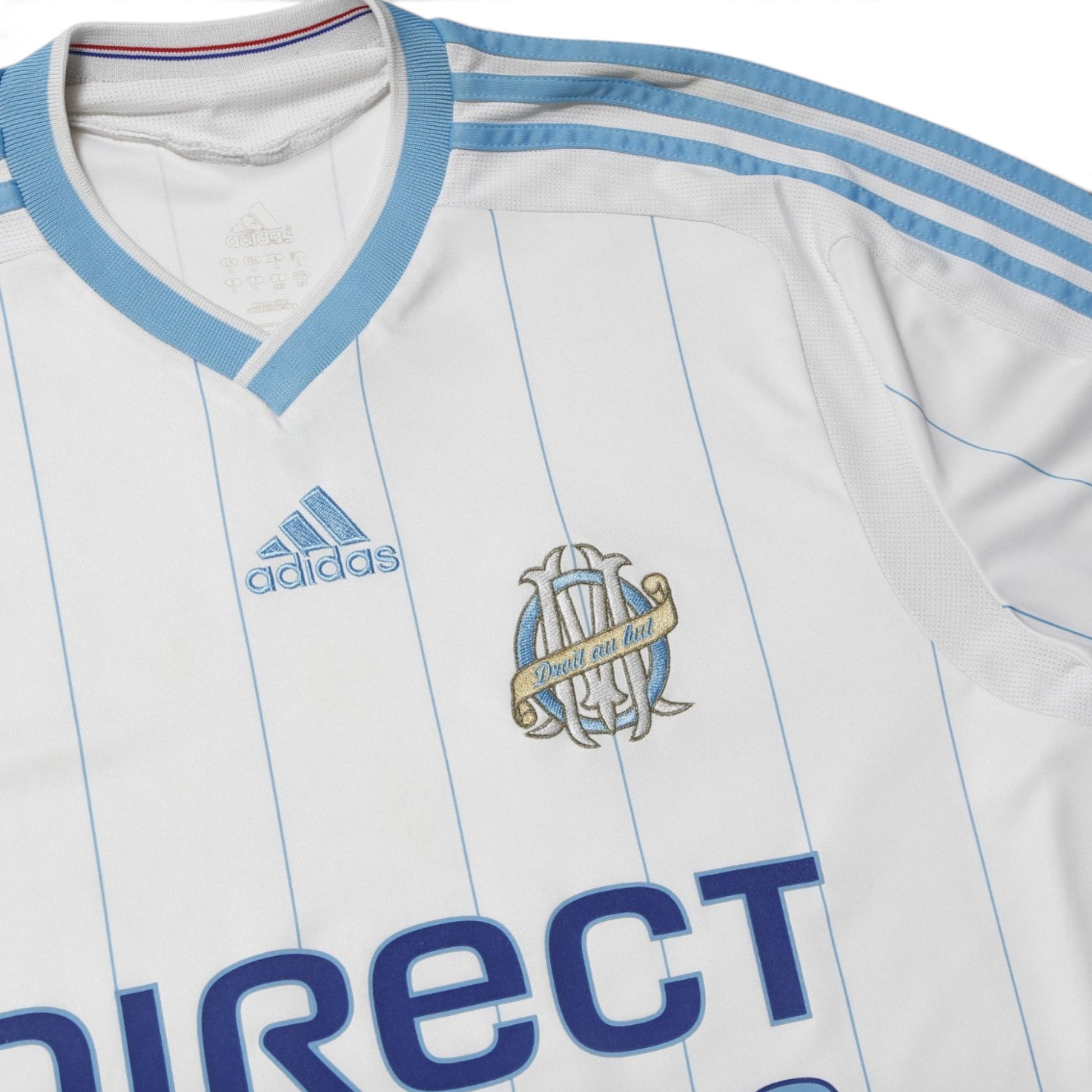 Close-up of adidas logo and OM crest on the chest