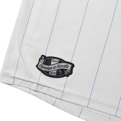 Close-up of Olympique de Marseille anniversary patch on the hem