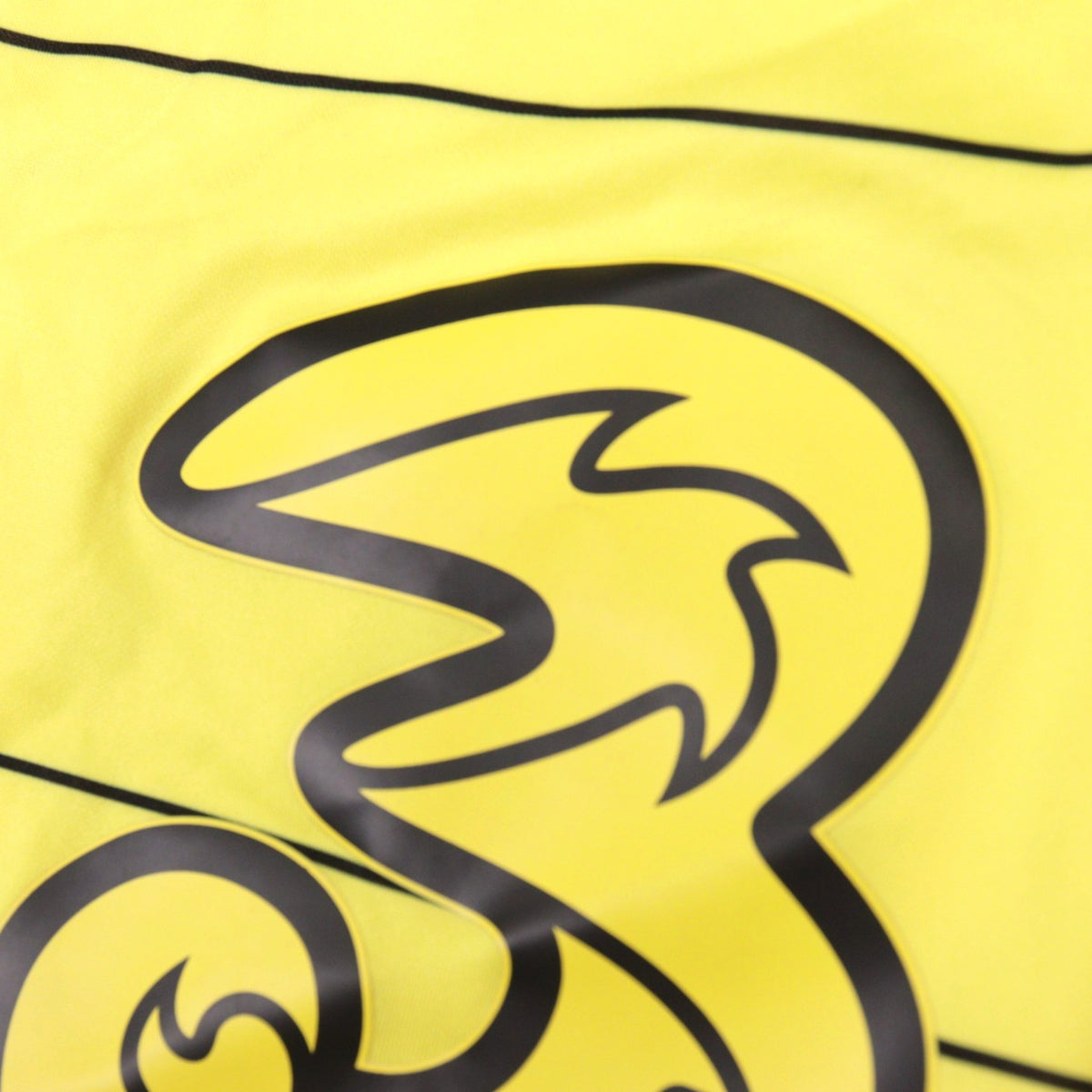 Close-up detail of the Three sponsor logo printed on the Chelsea away shirt