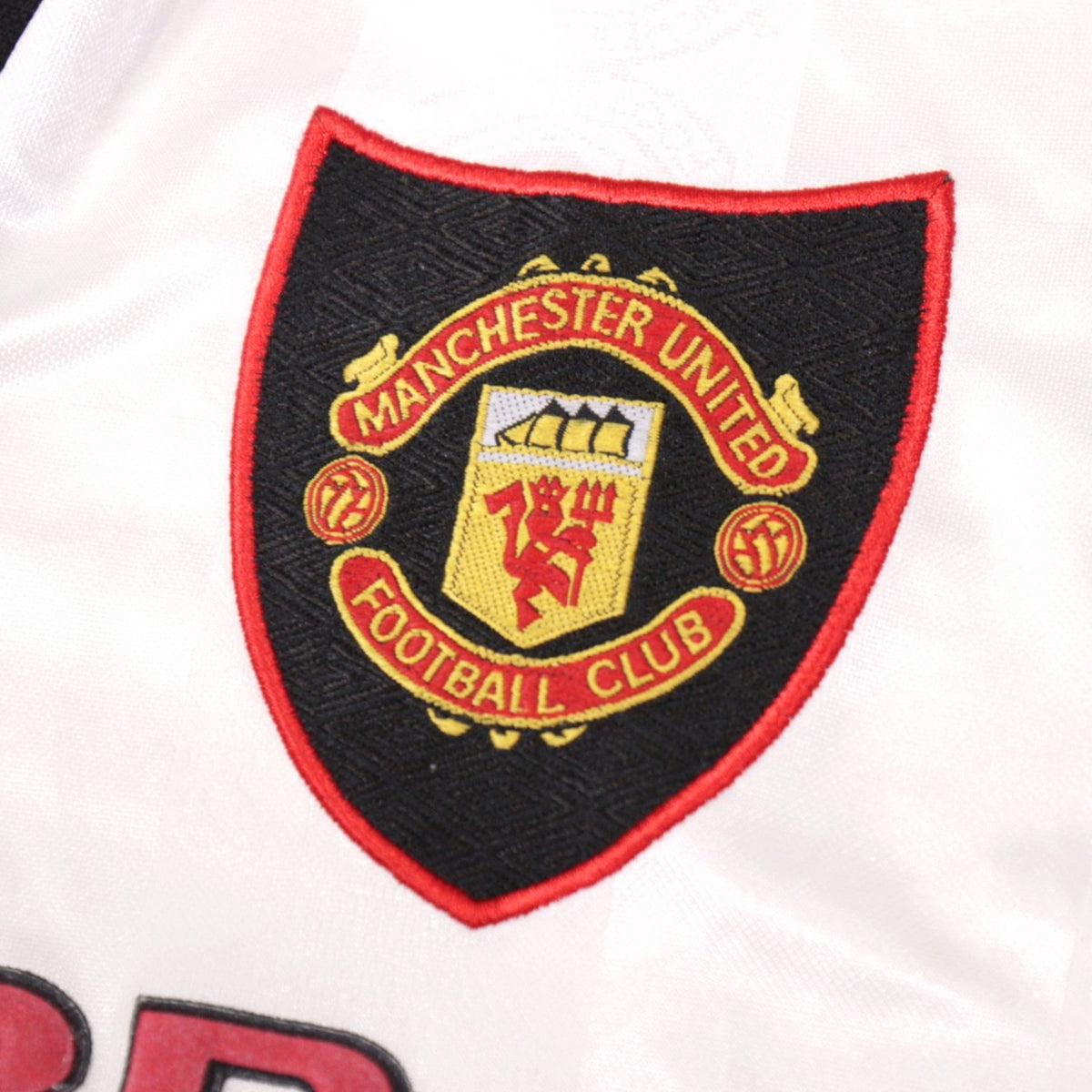 Close-up of embroidered Manchester United crest on the shirt