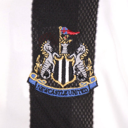 Close-up of the embroidered Newcastle United crest on the shirt