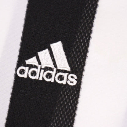 Close-up of the adidas logo embroidered on the chest stripe
