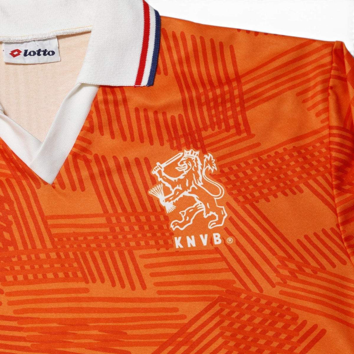Close-up of KNVB lion crest and Lotto logo on Netherlands home shirt