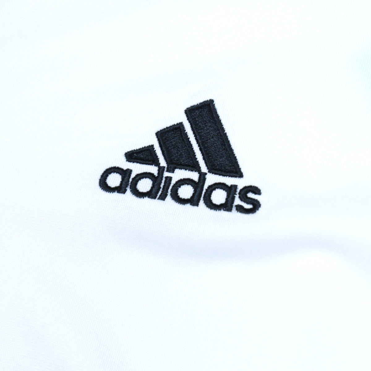 Close-up of the adidas logo embroidered on the chest