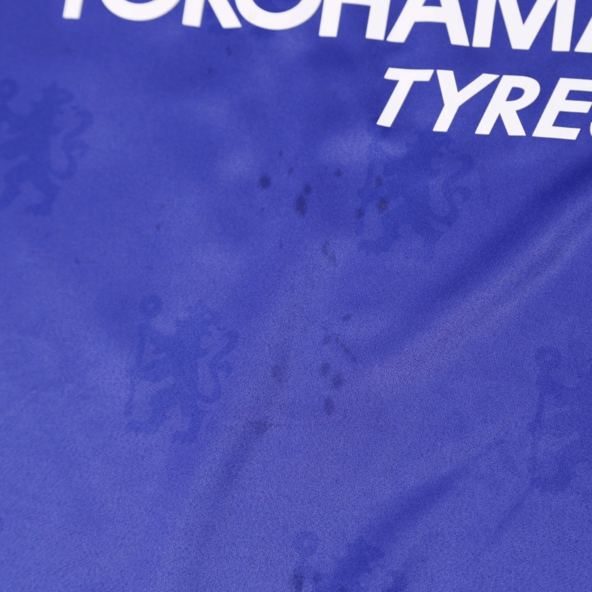Close-up of fabric showing faint marks near the Yokohama Tyres sponsor