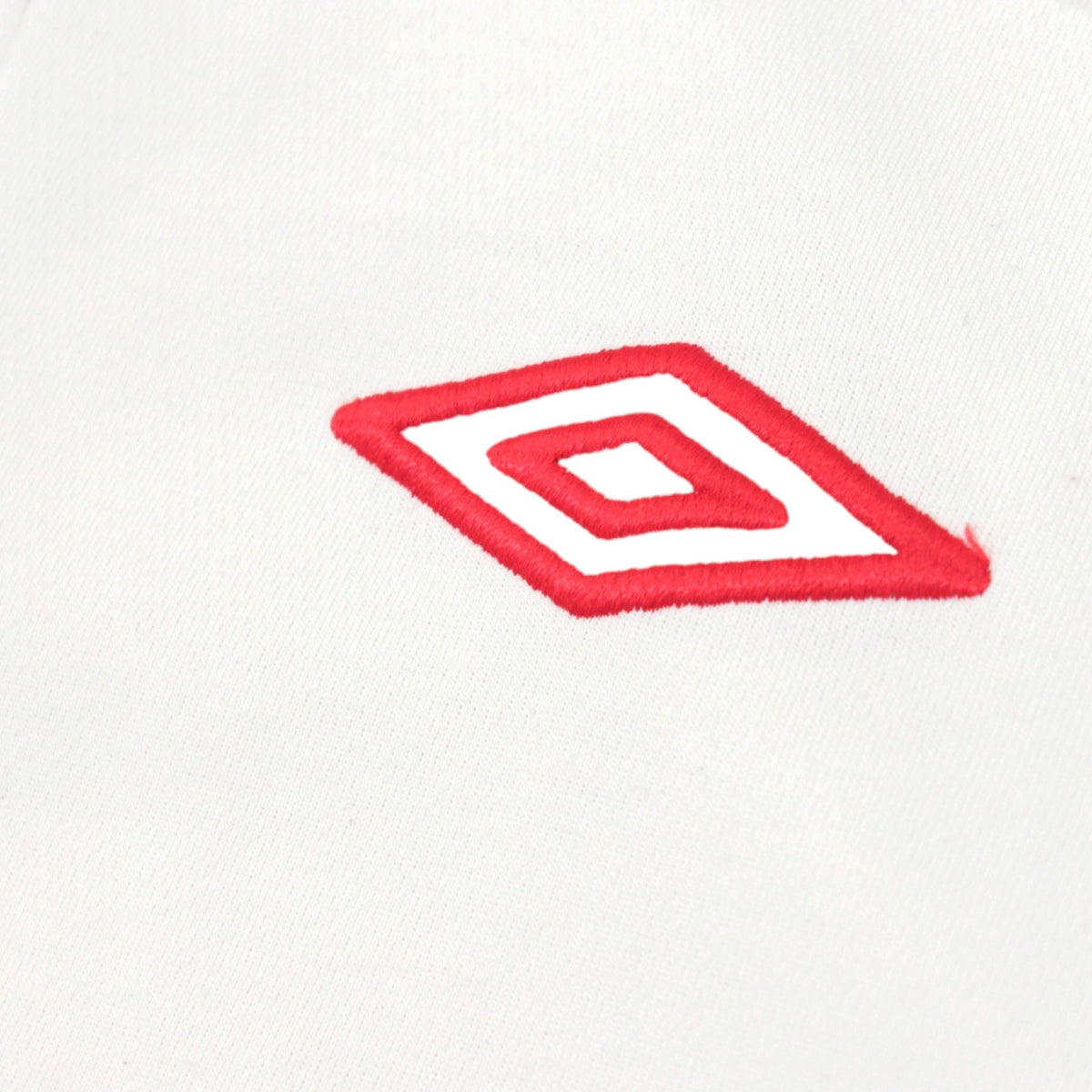 Close-up of the red Umbro diamond logo on the chest