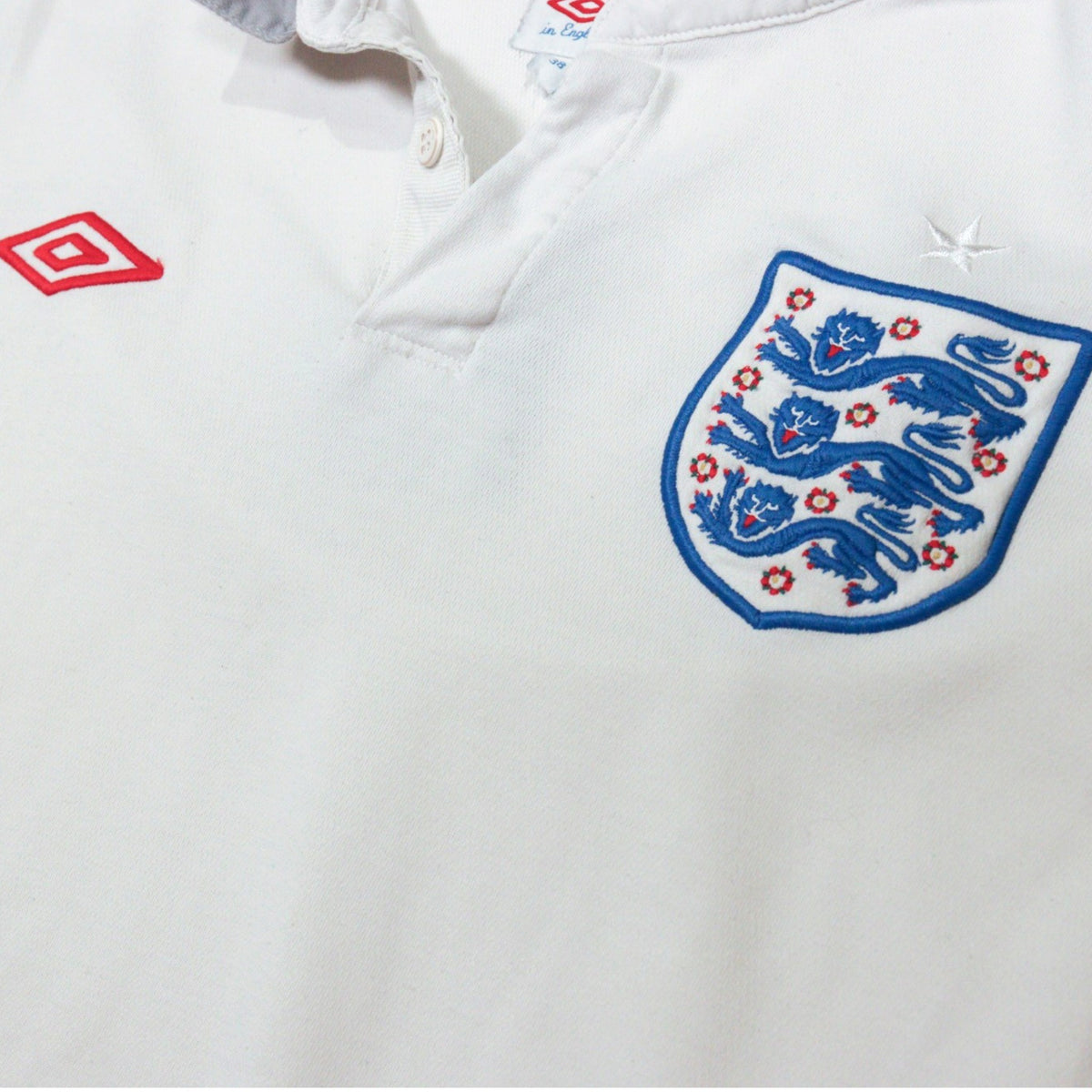 Close-up of the collar, button placket and crest on the England shirt