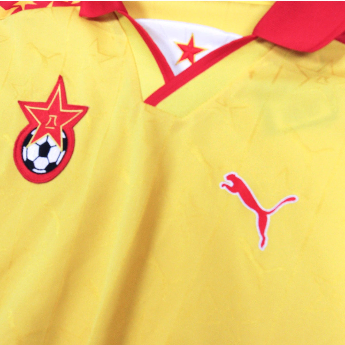 Close-up of the collar, Puma logo and club crest on the Bayi FC shirt