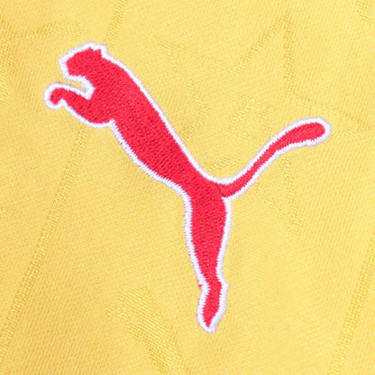Close-up of the red Puma logo on the shirt fabric