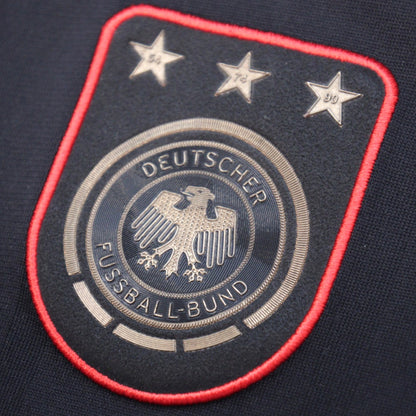 Close-up of the DFB crest with three World Cup stars on the 2010/11 Germany away shirt