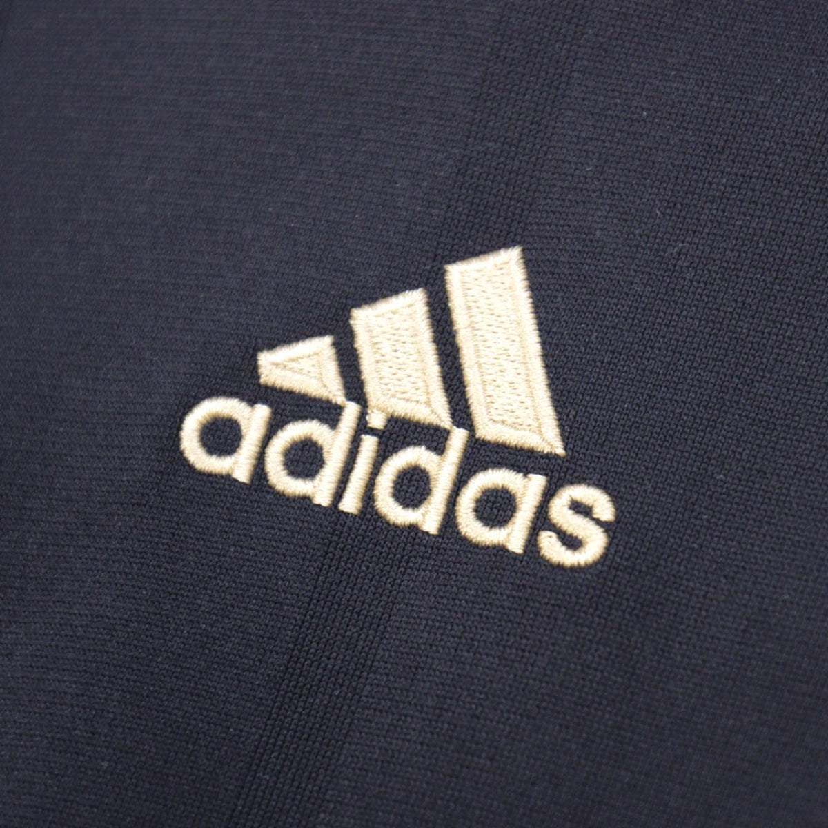 Close-up of the adidas logo embroidered on the chest of the Germany away shirt